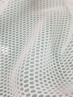 an image of a white netted surface with small circles on the top and bottom