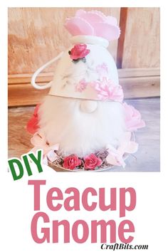 a white vase with pink flowers on it and the words diy teacup gnome