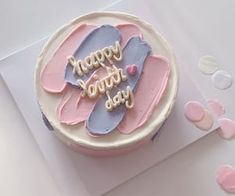 a birthday cake with pink and blue frosting