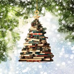 a christmas tree made out of books hanging from a branch