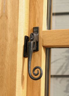 an iron door handle on a wooden door