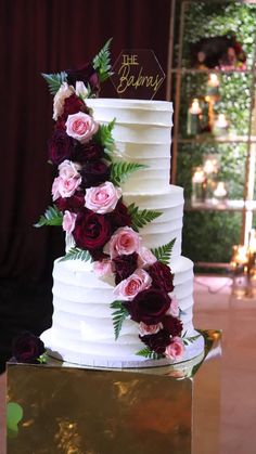 a three tiered cake with flowers on it