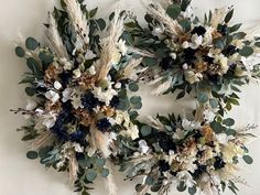 two wreaths made out of dried flowers and leaves