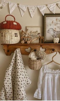 a shelf filled with baskets and other items on top of a wooden shelf next to a white wall