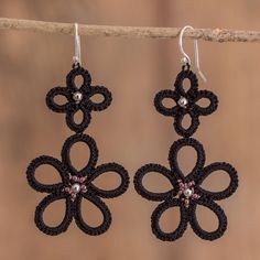 Tatting is a traditional technique that dates back to the 17th century. Often featuring oval and windy shapes, this precious art resembles laces made by hand, adding a sweet accent to any item, like Guatemala's Gladys Pichola creations. This time, she makes floral dangle earrings in a black tone, adding glass and sterling silver beads to the design. The accessory also features sterling silver hooks that allow a comfortable fit. Hand Tats, Red Petals, Black Earrings Dangle, Bold Earrings, Pumpkin Colors, Fall Earrings, Lace Making, Pearl Earrings Dangle, Pretty Earrings