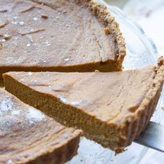 a close up of a pie on a glass plate with one slice cut out and ready to be eaten