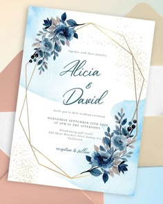 an elegant wedding card with blue flowers and gold foil on the front, featuring a watercolor