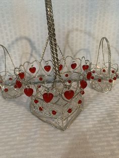 Add a touch of romance to your home decor with this set of three heart-shaped twisted wire baskets. Each basket features red plastic hearts and beads, making them perfect for Valentine's Day or any romantic occasion. The baskets come in medium size and are ideal for decoration purposes in any room of your house. They are made of sturdy wire material and have an item length of 7 inches for the large one and 3 inches for the small ones. These baskets are suitable for adults and come unboxed. The v Valentine’s Gift Basket, Vday Basket, Valentines Basket, Kids Gift Baskets, Valentine Baskets, Valentines Gift Bags, Beads Making, Romantic Themes, Unique Valentines