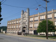 an old building on the corner of a street with power lines in front of it