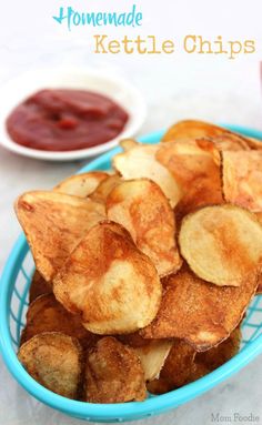 homemade kettle chips in a blue bowl with ketchup and sauce on the side