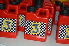 several red plastic containers with yellow numbers and checkered design on the side, sitting next to each other