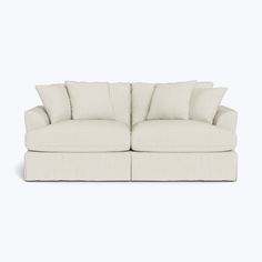 a white couch with four pillows on it