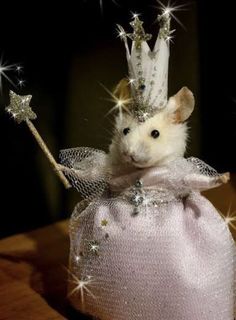 a small mouse in a pink dress with a crown on top of it's head