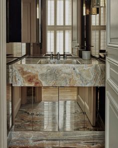 a bathroom with marble counter tops and walls