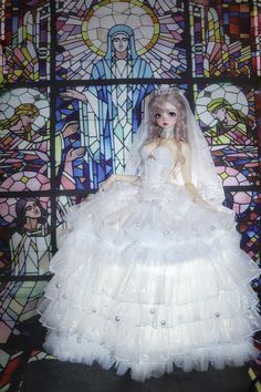 the doll is wearing a white wedding dress