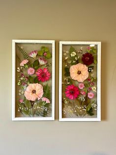 two white frames with pink and red flowers in them on the wall next to each other