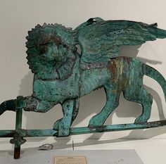 a statue of a lion with wings on it's back