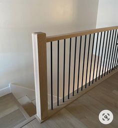 an empty room with white walls and wooden railings on the bottom floor is pictured in this image