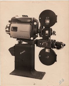 an old black and white photo of some type of camera on a tripod stand