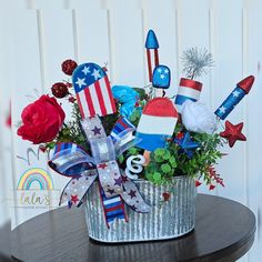 a patriotic arrangement in a bucket on a table