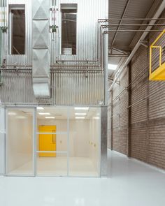 the inside of a storage building with yellow doors