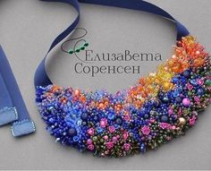 an image of a necklace made out of beaded beads on a blue ribbon with the words evababema copehen