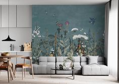 a living room filled with furniture next to a wall mural on the side of a wall