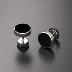 Unleash your inner style maverick with our Men's Stainless Steel Stud Earrings in sleek black. Crafted for the modern trendsetter, these earrings blend contemporary edge with timeless sophistication. Forged from high-quality stainless steel, these studs exude durability and resilience, ensuring they stand the test of time. The sleek black finish adds a touch of understated elegance, making them versatile enough to complement any ensemble, whether casual or formal. With a minimalist design, these earrings offer a subtle yet impactful accent to your look, effortlessly elevating your style game. Lightweight and comfortable to wear, they are perfect for everyday wear or special occasions, adding a dash of confidence and charisma to your persona      Earrings Height: 10mm Width: 10mm     Materi Modern Black Jewelry With Black Enamel, Modern Stainless Steel Earrings, Modern Matte Black Jewelry For Formal Occasions, Matte Black Modern Jewelry For Formal Occasions, Modern Internally Threaded Metal Plug Earrings, Modern Internally Threaded Adjustable Earrings, Modern Black Hypoallergenic Jewelry, Modern Black Jewelry, Modern Black Round Jewelry