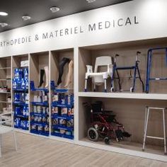 the interior of a medical store with various items on shelves and chairs in front of it