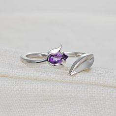 Sterling Silver Purple Amethyst Tulip Flower Leaf Detail Ring. Set with a pear shaped natural African Purple Amethyst. The ring is an adjustable design in two sizes. I'm a big fan of developing designs for adjustable rings. They give that bit of flexibility if your size varies with the seasons, as mine does, or convenience if you're buying a gift that it will fit the recipient. Topaz are associated with love self esteem and good fortune. They are the birthstone for December. Finished with a commercial grade rhodium plate to give a high quality shine finish. Supplied in an Ojewellery presentation box, within a ribbon handled gift bag, complete with product information authenticity card with space for a gift message and a jewellery cleaning cloth to keep your jewellery in ready to wear condi Tulip Ring, Pretty Jewelry Necklaces, Tulip Flower, Flower Leaf, Detailed Ring, Pretty Jewelry, Purple Band, Argentium Silver, Tulips Flowers