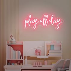 a pink neon sign that reads, page all day on the wall above a desk