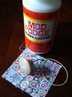 a bottle of wood glue sitting on top of a piece of cloth next to a string