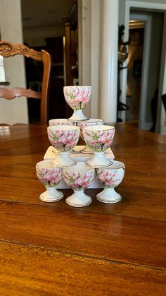 there is a stack of cups on top of each other at the dining room table