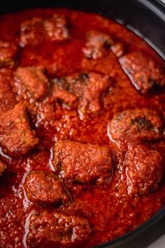 meatballs covered in marinara sauce in a slow cooker