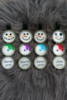 six bottle caps with snowmen on them are sitting on a fur covered surface,