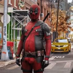 a deadpool is standing in the street