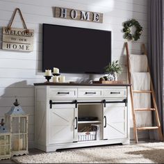 a living room with a large tv on top of a wooden cabinet next to a ladder