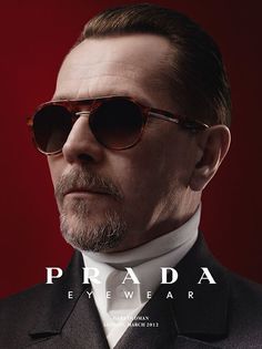 a man in a suit and tie with sunglasses on the cover of prada magazine