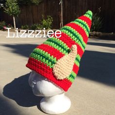 a knitted elf's hat on top of a mannequin head