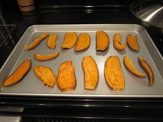 some cut up pumpkins on a pan in the oven