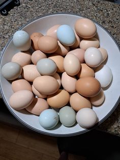 a white bowl filled with eggs on top of a counter