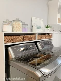 a washer and dryer sitting next to each other in a room with white walls