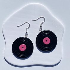 pair of black and pink vinyl record earrings