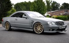 a grey mercedes benz coupe parked on the street