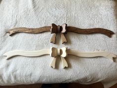 three pieces of wood sitting on top of a bed