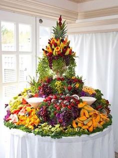 a table topped with lots of different types of fruits and veggies on top of it