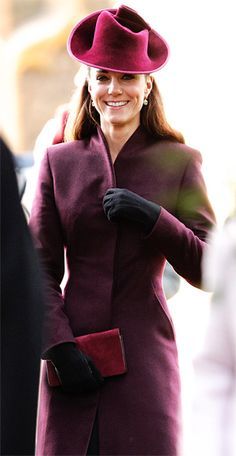 the woman is wearing a purple coat and hat