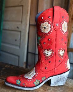 DESCRIPTION The Liberty Black Anabella Nubuck Grace Rojo Boot combines classic western style with whimsical details like a flower heart and star inlay, star and circle studs, and intricate stitching. Stand out from the crowd with this vibrant red cowboy boot, featuring a convenient zipper for easy on and off. Measurements: Shaft Height - 11" Heel Height - 2" Toe - Snip Standard Width Measurements are based on size 8 - measurements may vary slightly based on size Sizing: Fits true to size Boot Wall, Cowgirl Things, Cow Boy Boots, Boy Boots, Emma Kate, Red Cowboy Boots, Ethiopian Opal Ring, Cute Nike Shoes, Cute Nike