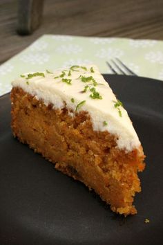 a piece of cake sitting on top of a black plate