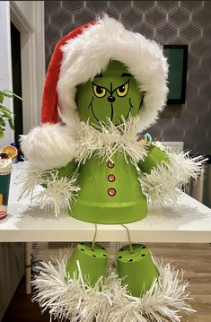 a green and white christmas decoration sitting on top of a table